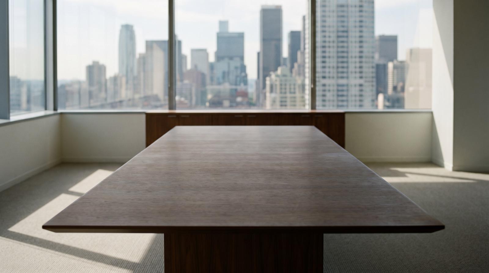 Illustrative photography — an empty meeting room overlooking a city